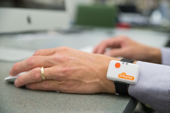 photo of Shimmer device on a wrist, wherein the hand is using a mouse and the other hand is using a keyboard
